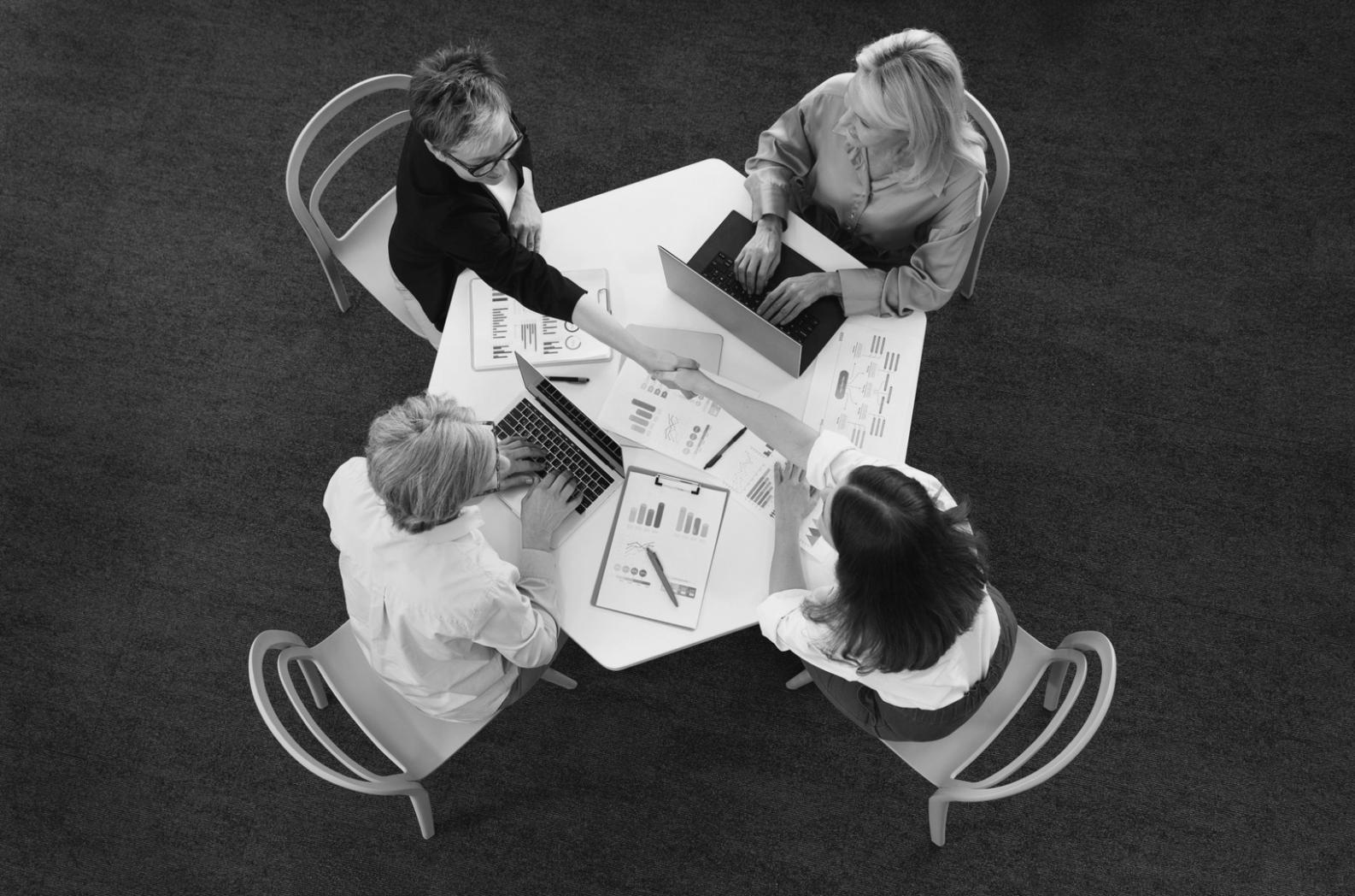 Business professional analyzing financial charts and data on computer screen